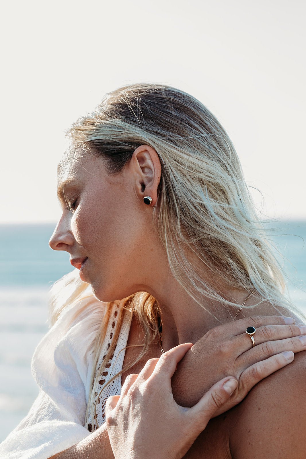 Blonde model wearing 9 Carat Gold Stud Earrings with rare Pirate/Black Sea Glass and Bubble Design made by Booblinka Jewellery