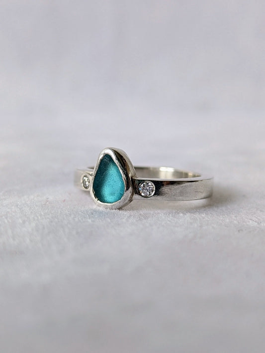 Aqua Blue Sea Glass and Moissanite Silver Ring  from Allure Collection on white velvet by Booblinka Jewellery