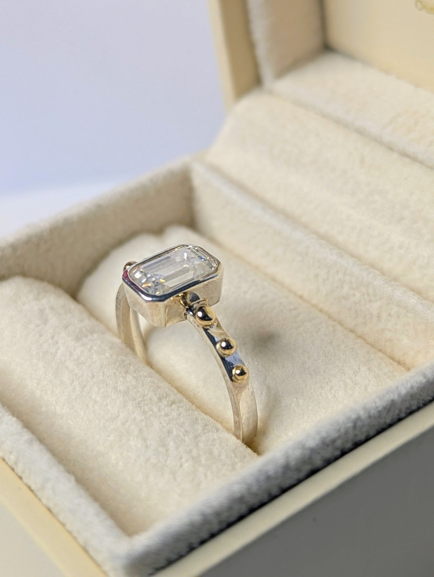 Emerald-Cut Moissanite and Gold Accent Ring  from DEI Collection in an ivory plush jewellery box by Booblinka jewellery