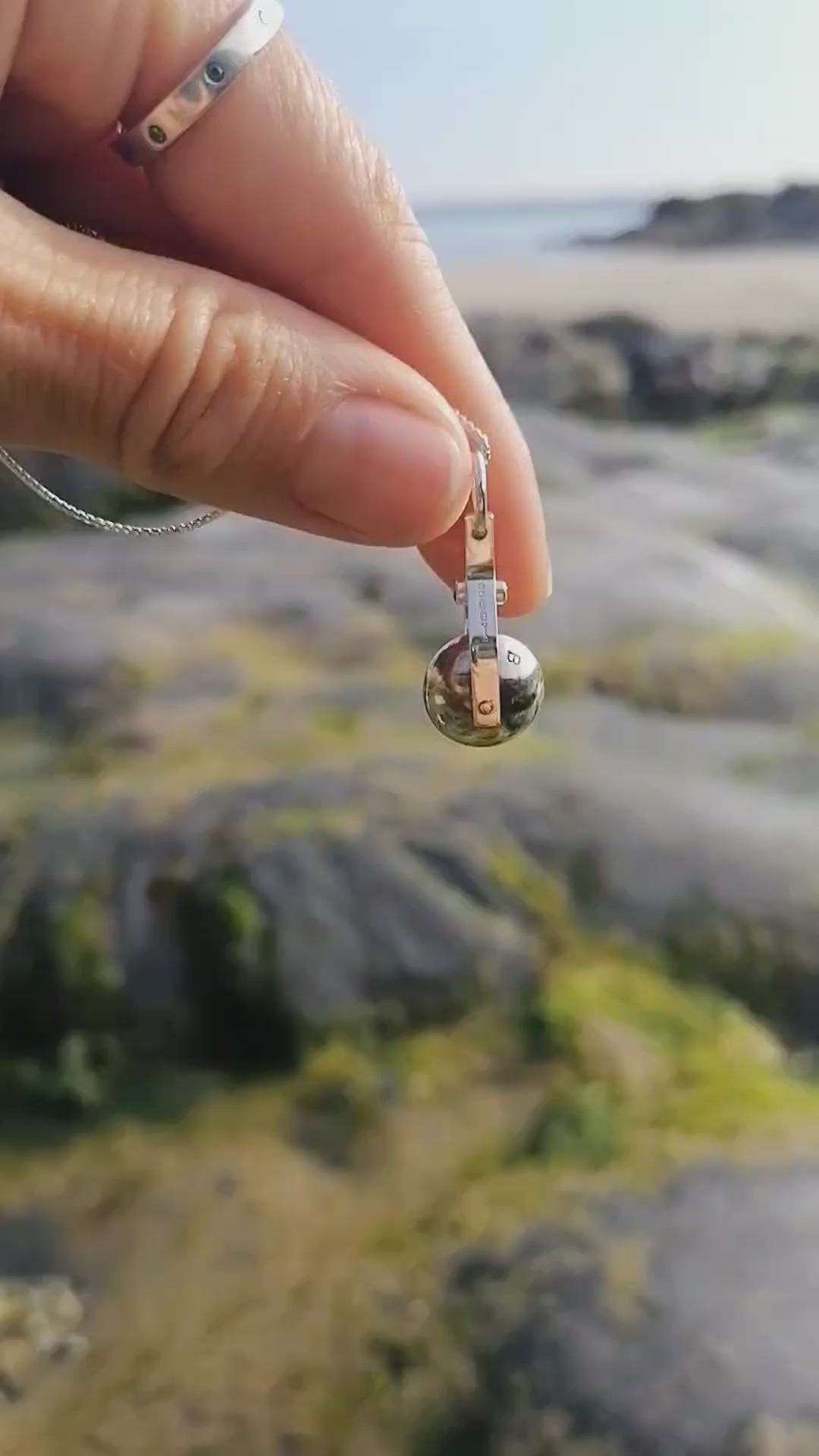 Video of the spinning moon necklace in sterling silver with a blue gemstone, showcasing its unique design as seen in 'Playing Nicely' by Booblinka Jewellery 