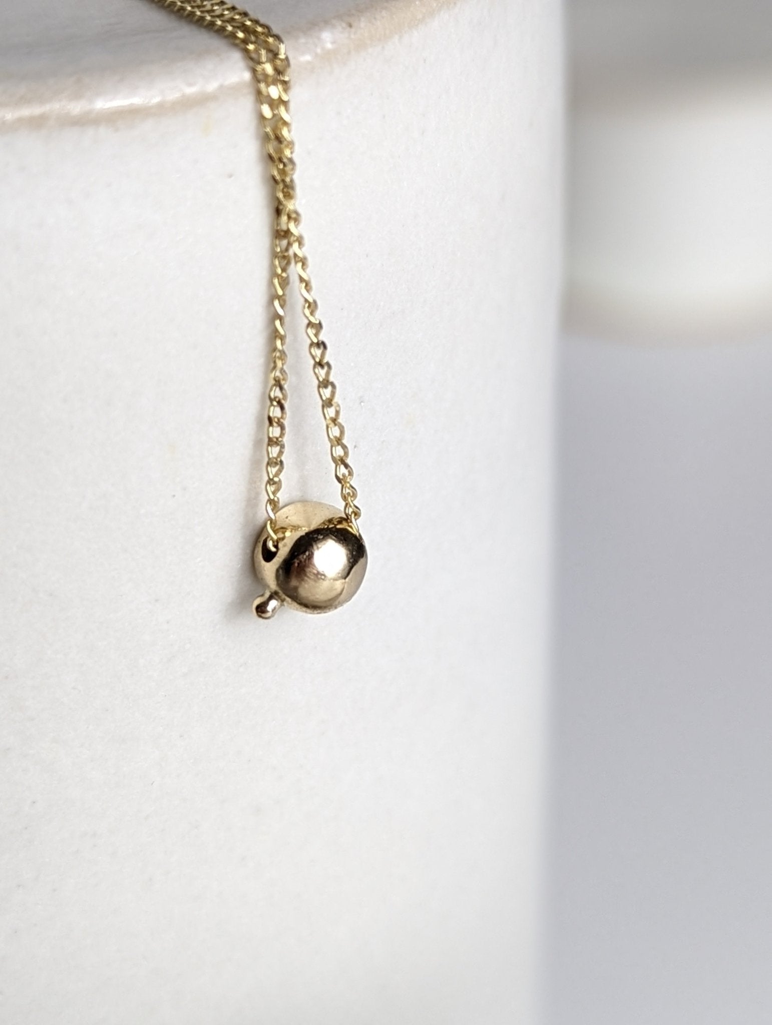 Delicate gold DEI necklace from back round setting with tiny granule - Booblinka Jewellery