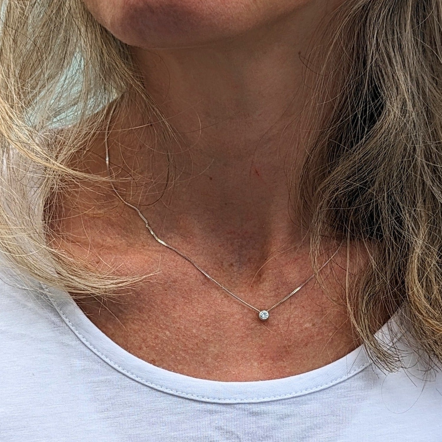 Model wears delicate silver DEI necklace with moissanite - Booblinka Jewellery